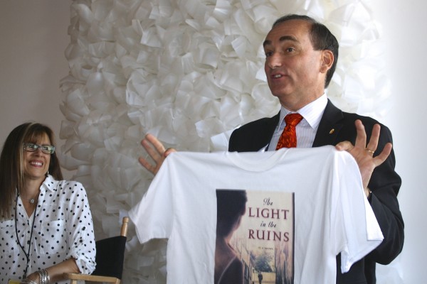 Chris displaying The Light in the Ruins tour teeshirt